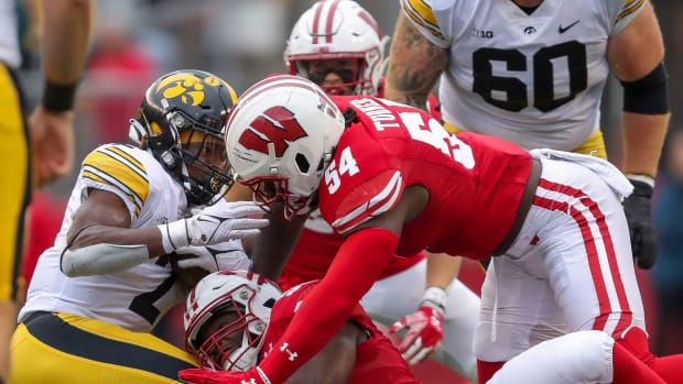 Wisconsin linebackers Maema Njongmeta (55) and Jordan Turner (54) tackle Iowa running back Kaleb Johnson (2) on Saturday, October 14, 2023, at Camp Randall Stadium in Madison, Wis. Iowa won the game, 12-6.